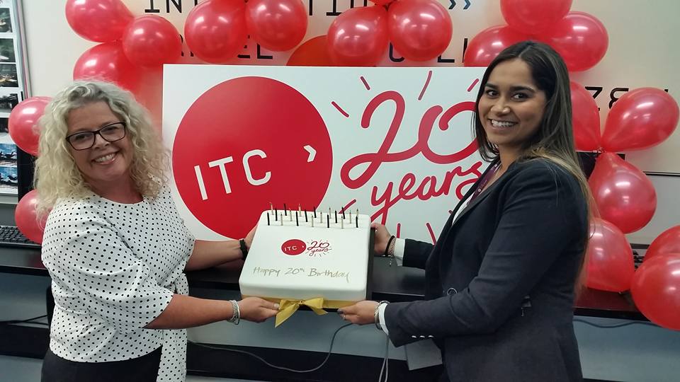 ITC Head of Group Services Michelle Chatfield and Student Services Advisor Sharon Roy pose with one of ITC's 20th birthday cakes. 